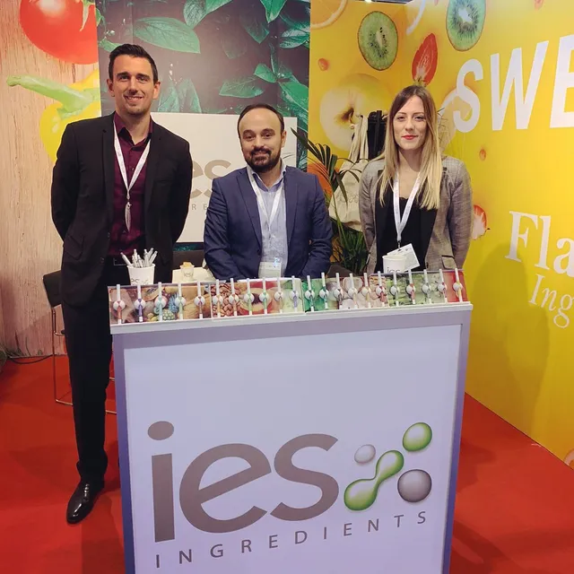 IES Ingredients team at professional trade show stand with natural ingredient samples
