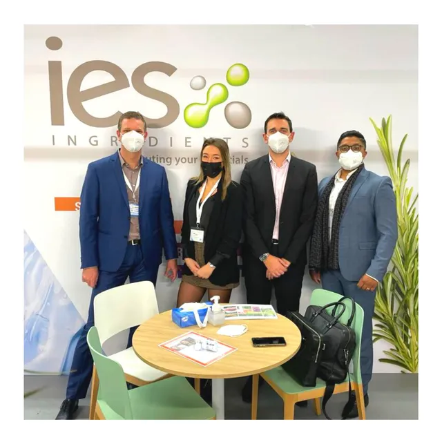 IES Ingredients team at a professional trade show - four colleagues in suits in front of the booth