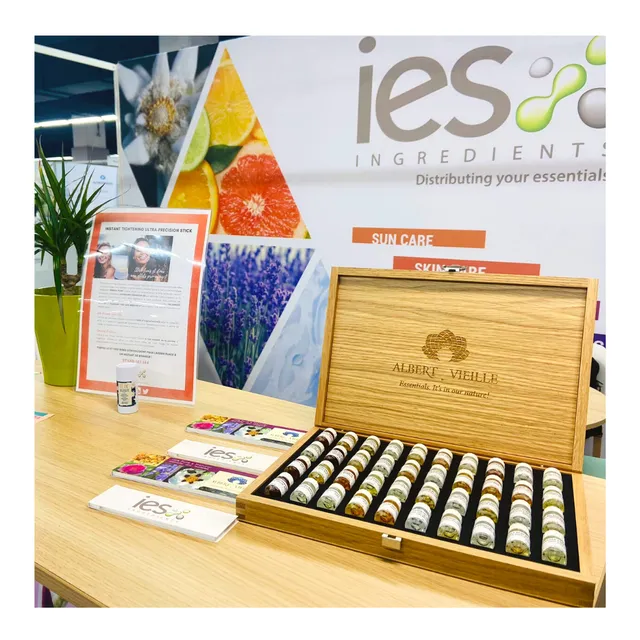 IES Ingredients booth with wooden box containing natural ingredient samples, colorful triangular logo